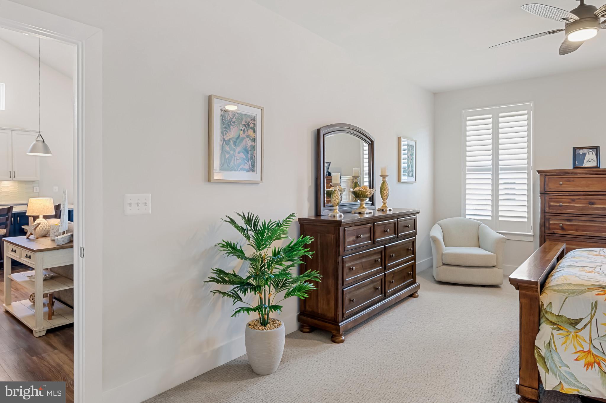 19437 Longfellow Way Georgetown, DE 19947 - Photo 29 of 33 a room with furniture and a potted plant