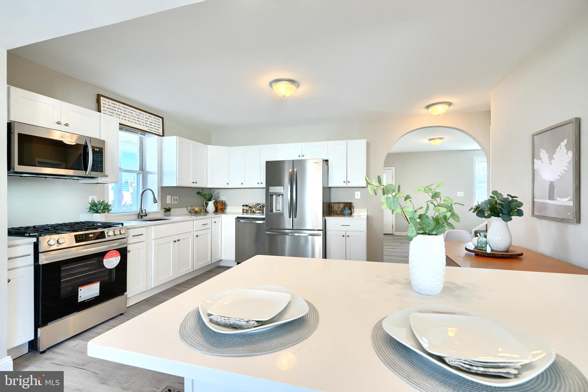 235 Pinewood Road Dundalk, MD 21222 - Photo 58 of 59 a kitchen with a white cabinets and stainless steel appliances