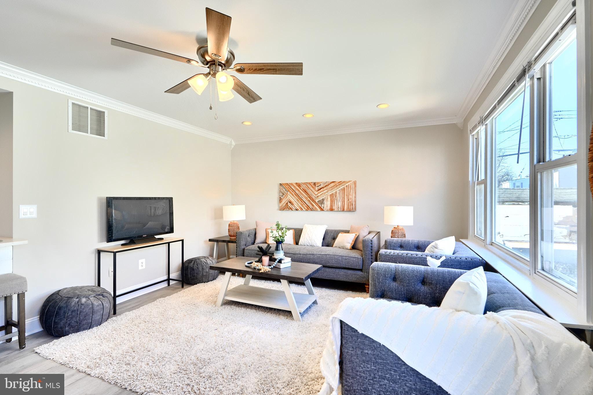 235 Pinewood Road Dundalk, MD 21222 - Photo 23 of 59 a living room with furniture and a flat screen tv