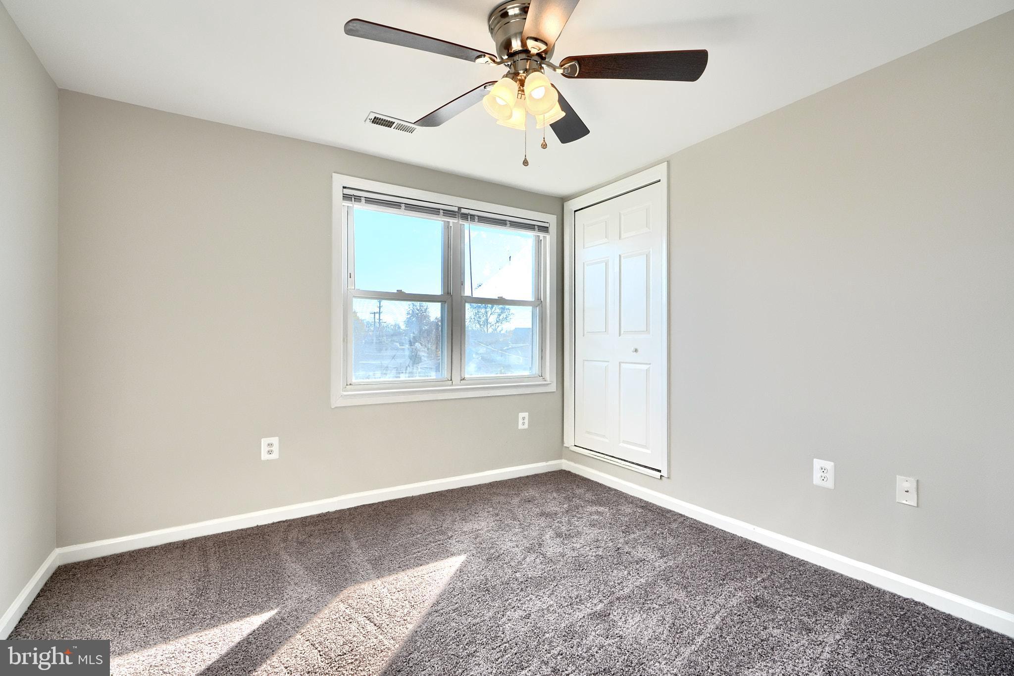 235 Pinewood Road Dundalk, MD 21222 - Photo 42 of 59 a view of an empty room with window and chandelier fan
