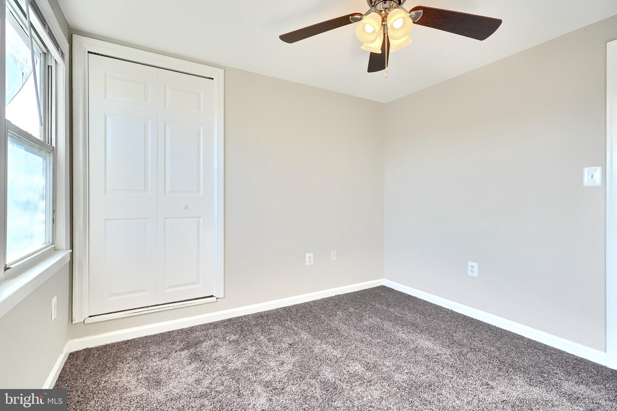 235 Pinewood Road Dundalk, MD 21222 - Photo 43 of 59 an empty room with a ceiling fan and window