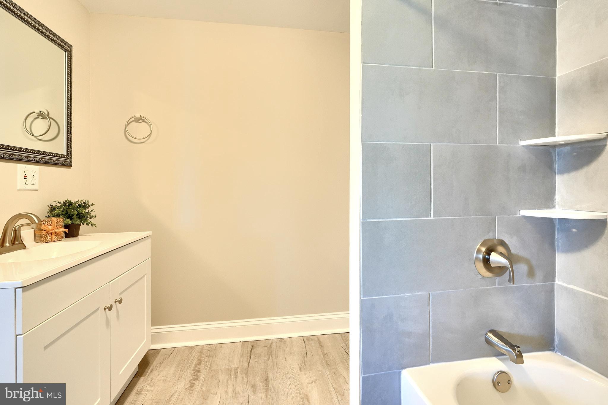 235 Pinewood Road Dundalk, MD 21222 - Photo 47 of 59 a bathroom with a sink and a mirror