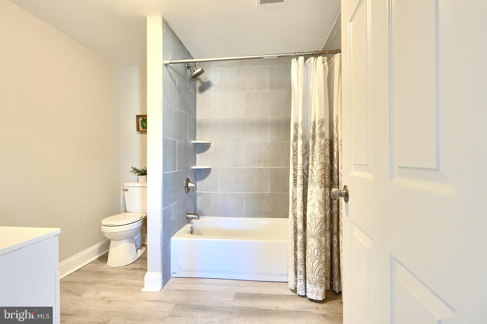235 Pinewood Road Dundalk, MD 21222 - Photo 48 of 59 a bathroom with a bathtub and a toilet