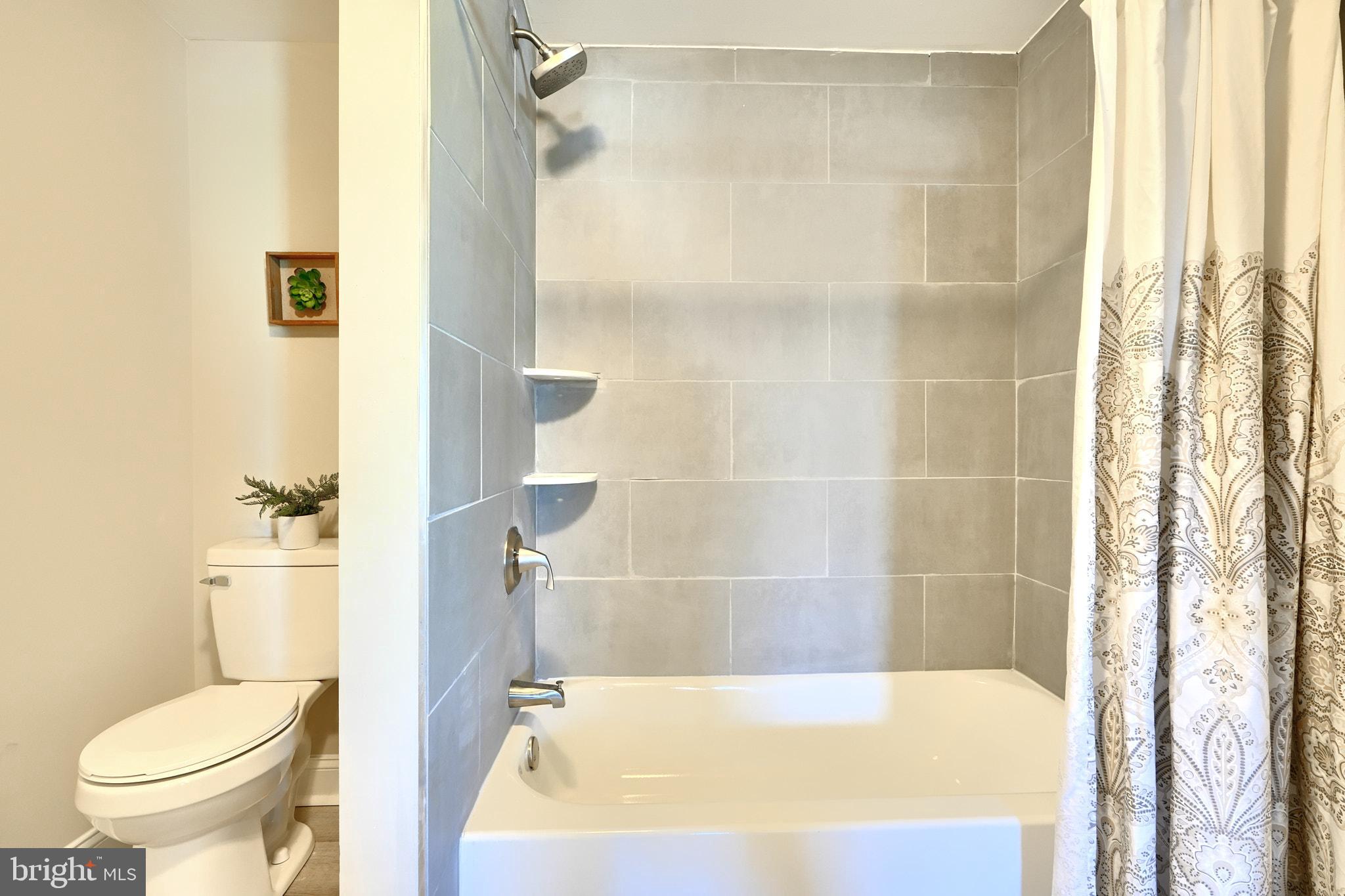 235 Pinewood Road Dundalk, MD 21222 - Photo 49 of 59 a bathroom with a bathtub and a shower
