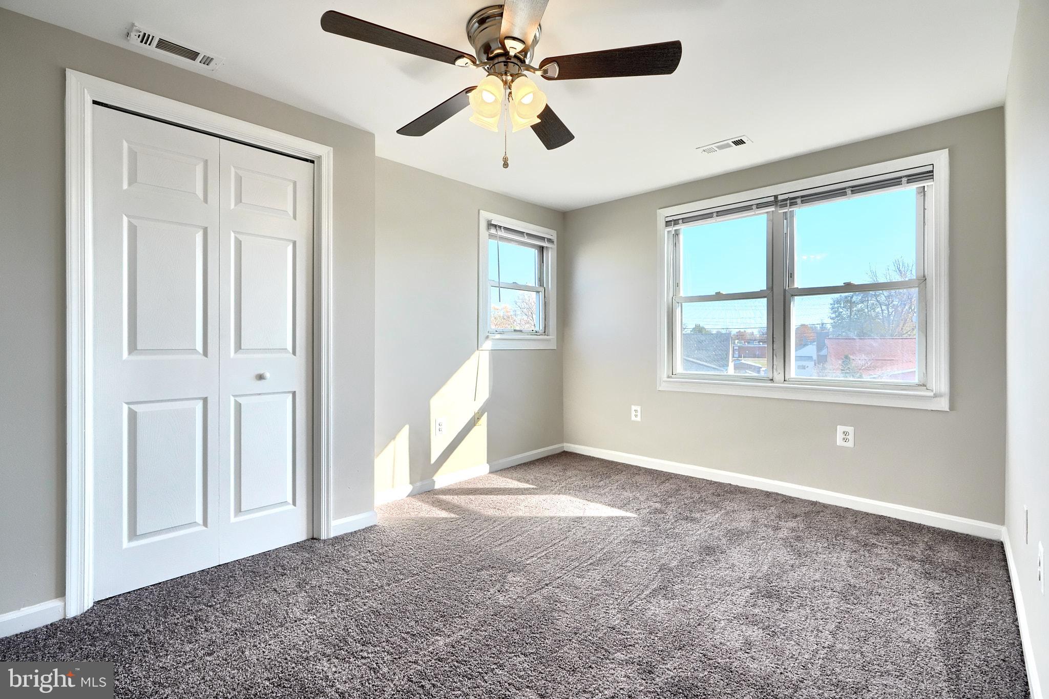 235 Pinewood Road Dundalk, MD 21222 - Photo 50 of 59 an empty room with windows and ceiling fan