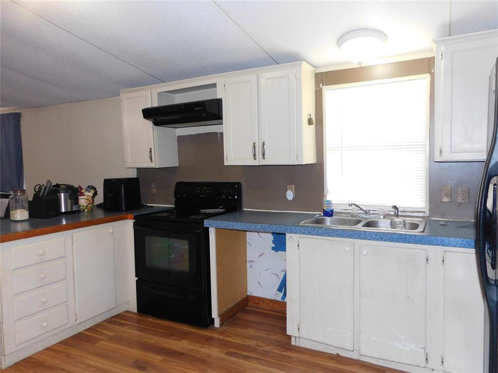 233 HCR 3315 Hubbard, TX 76648 - Photo 26 of 31 a kitchen with a sink and cabinets