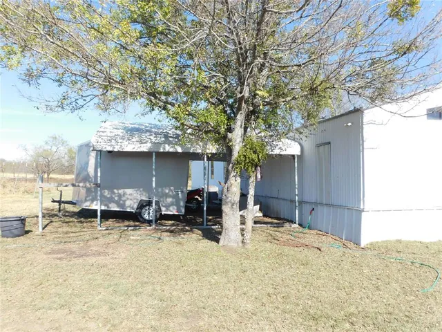 a backyard of a house with table and chairs