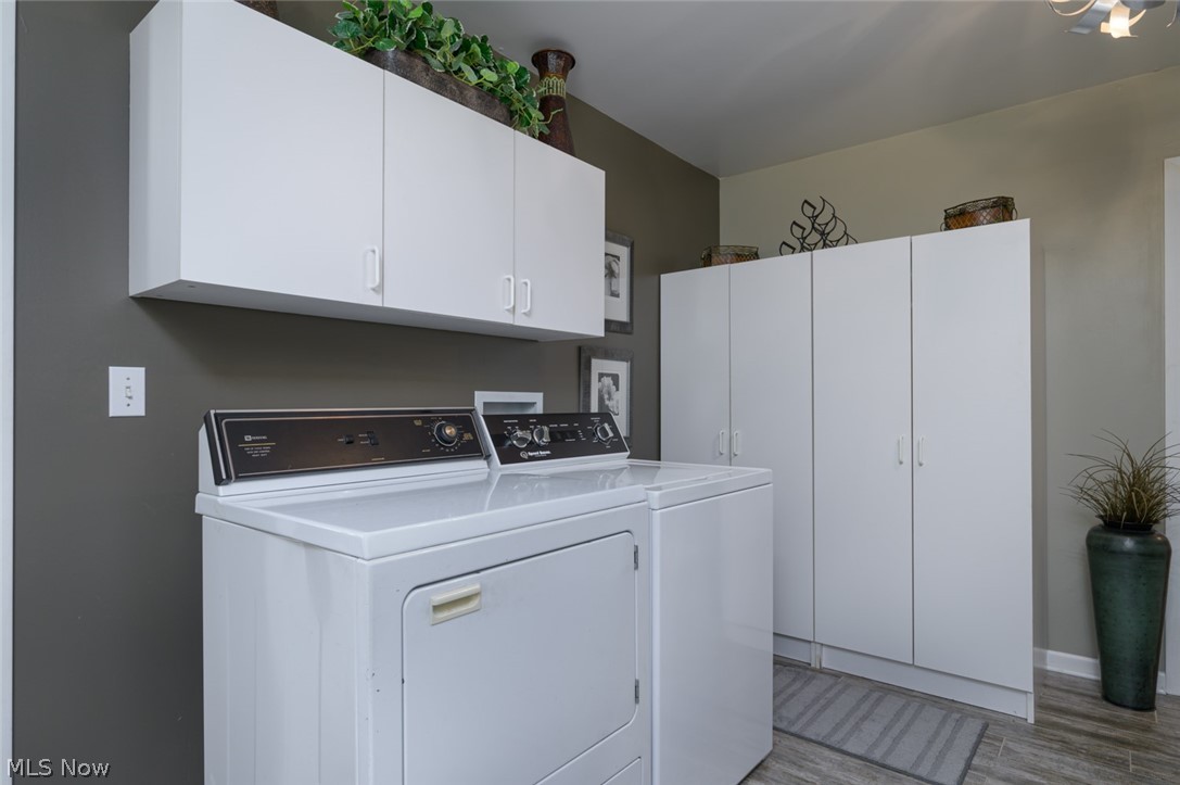 1817 Steffy Road Mogadore, OH 44260 - Photo 33 of 49 First Floor laundry room featuring ceramic flooring, washer and dryer hookups and spacious cabinetry