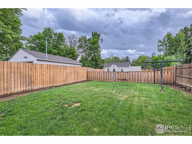 a view of a house with wooden fence