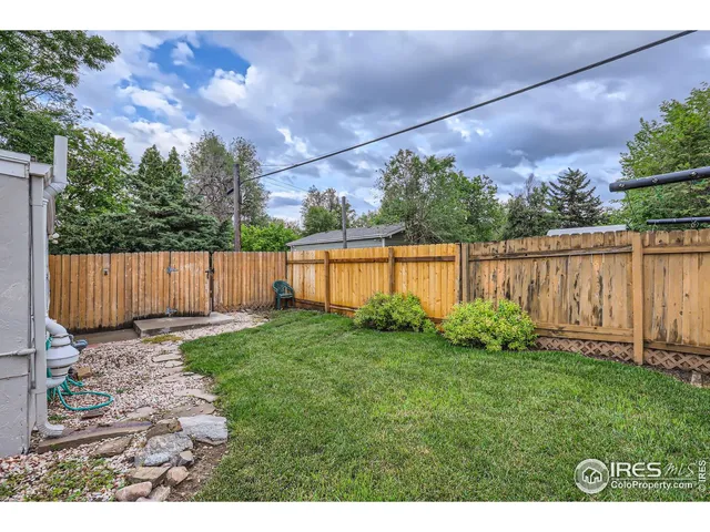 a view of a barn in the middle of a yard