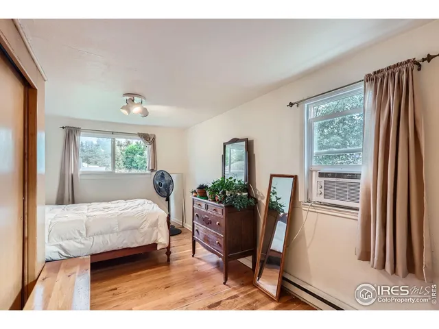 a view of a house with a yard and wooden fence