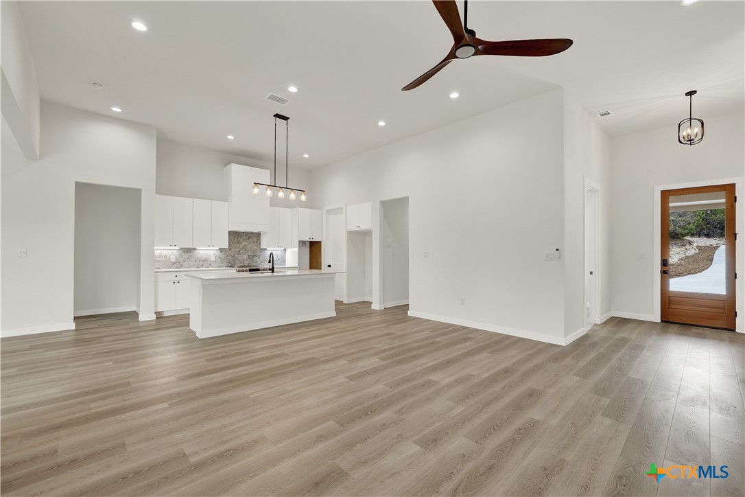 328 Compass Rose Spring Branch, TX 78070 - Photo 5 of 48 a view of kitchen with kitchen island wooden floor center island and stainless steel appliances