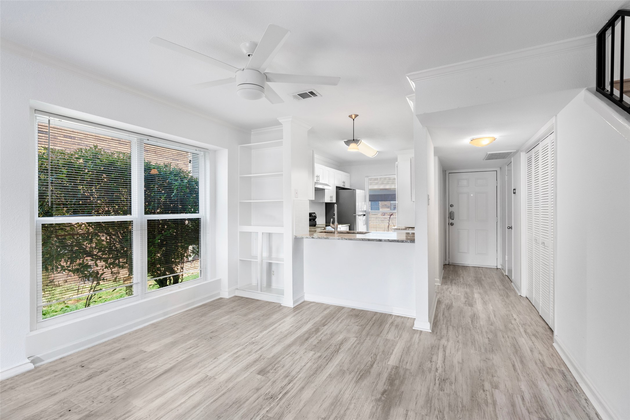2018 West Rundberg Lane, Unit 16D Austin, TX 78758 - Photo 5 of 18 Luminous living area transitions seamlessly into an efficient kitchen, ideal for modern living.