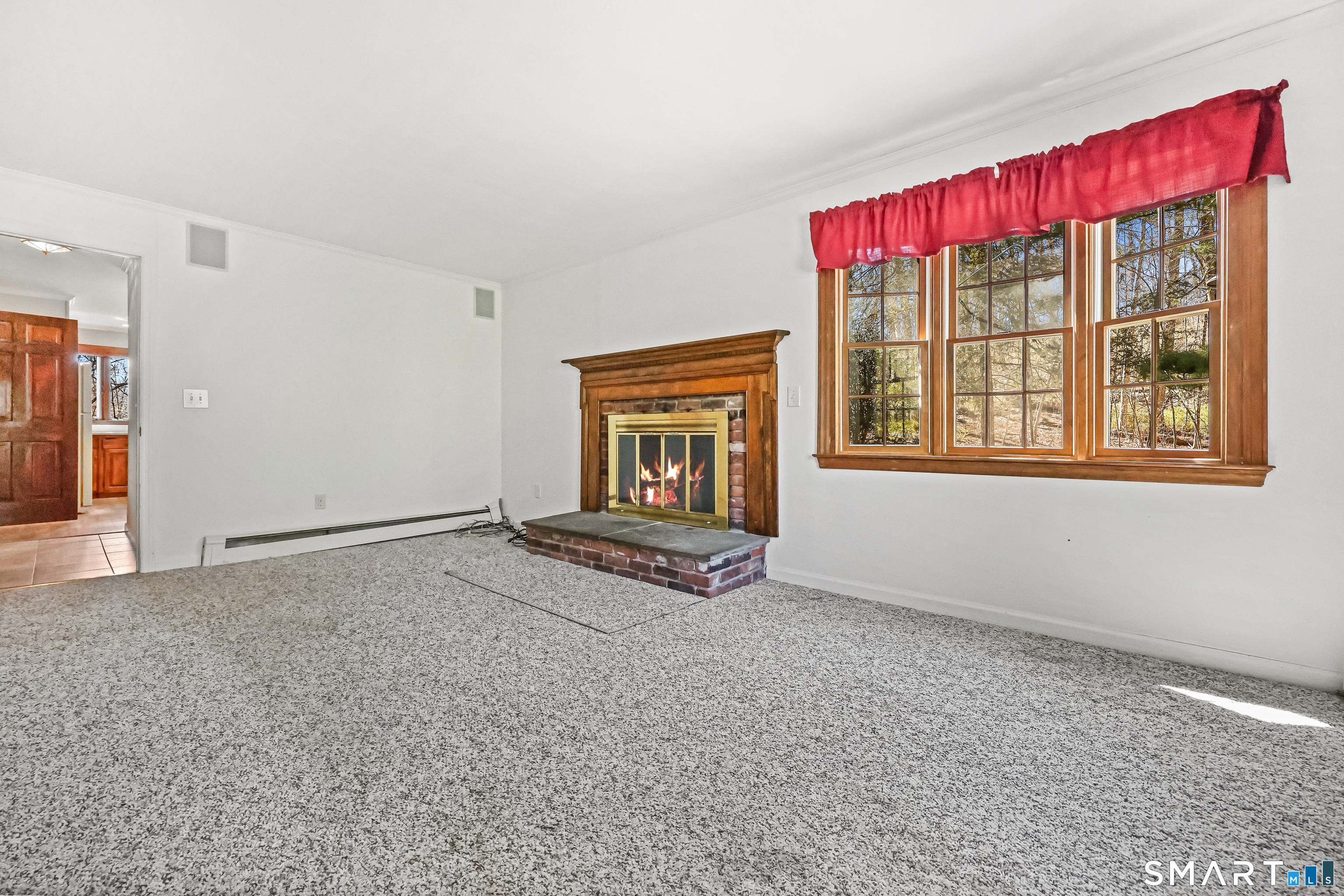 145 Wilton Road East Ridgefield, CT 06877 - Photo 7 of 35 Family room with fireplace and parquet floors under the carpet.