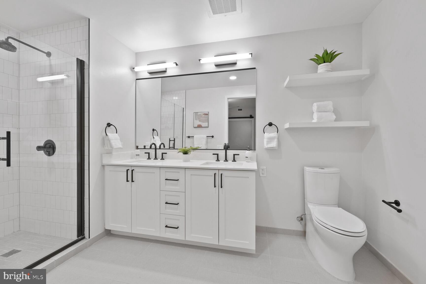 1211 Van Street Southeast, Unit 613 Washington, DC 20003 - Photo 14 of 28 a bathroom with a double vanity sink mirror and toilet
