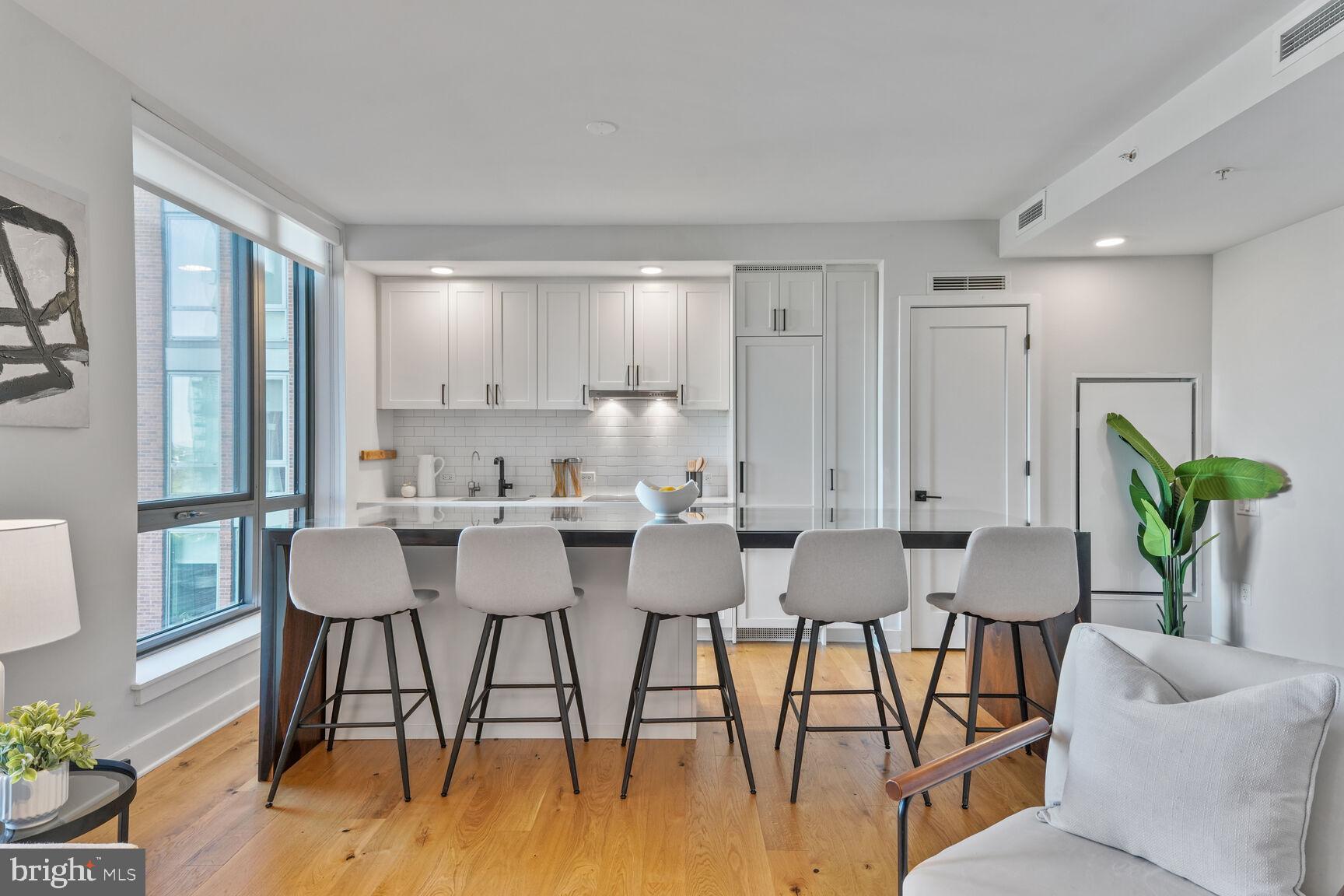 1211 Van Street Southeast, Unit 613 Washington, DC 20003 - Photo 6 of 28 a view of a dining room with furniture and wooden floor