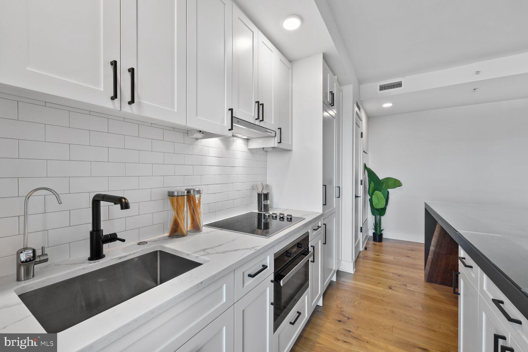 1211 Van Street Southeast, Unit 613 Washington, DC 20003 - Photo 10 of 28 a kitchen with stainless steel appliances a sink stove and cabinets