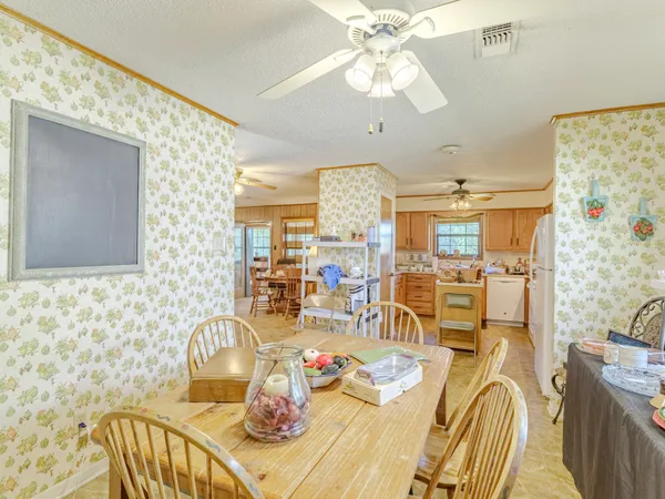 a view of a dining room with furniture a chandelier and a flat screen tv