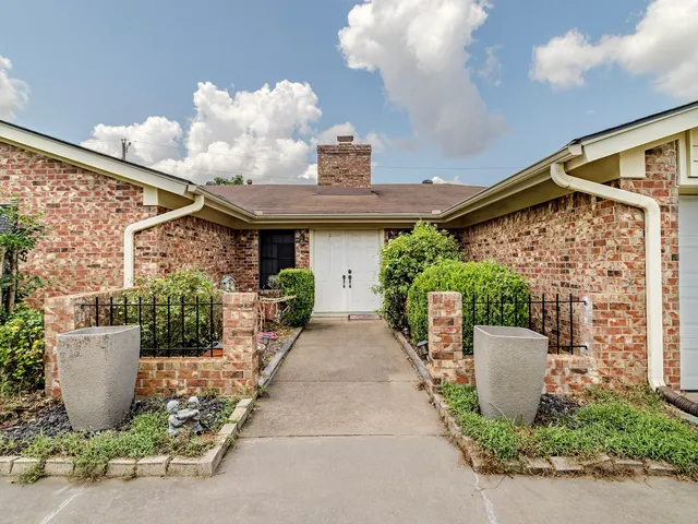a view of a patio with table and chairs and potted plants