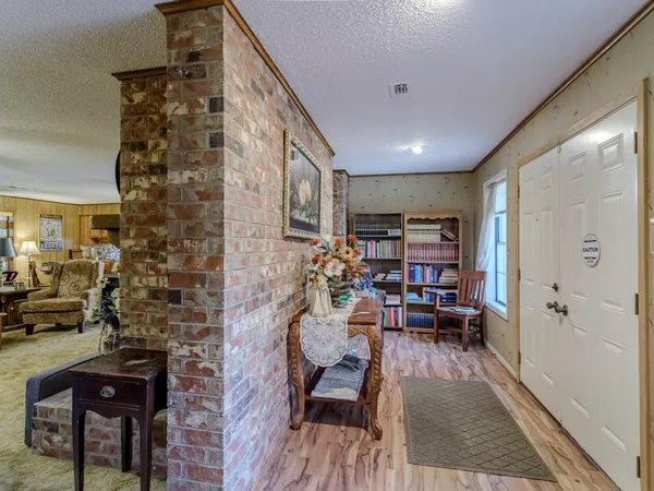 a living room with furniture and a book shelf