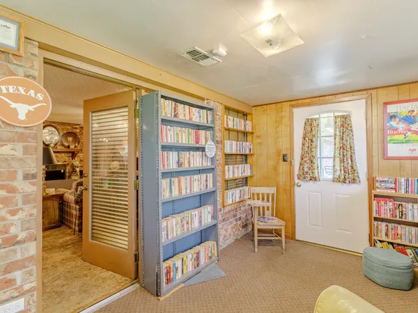 a living room with furniture and a book shelf