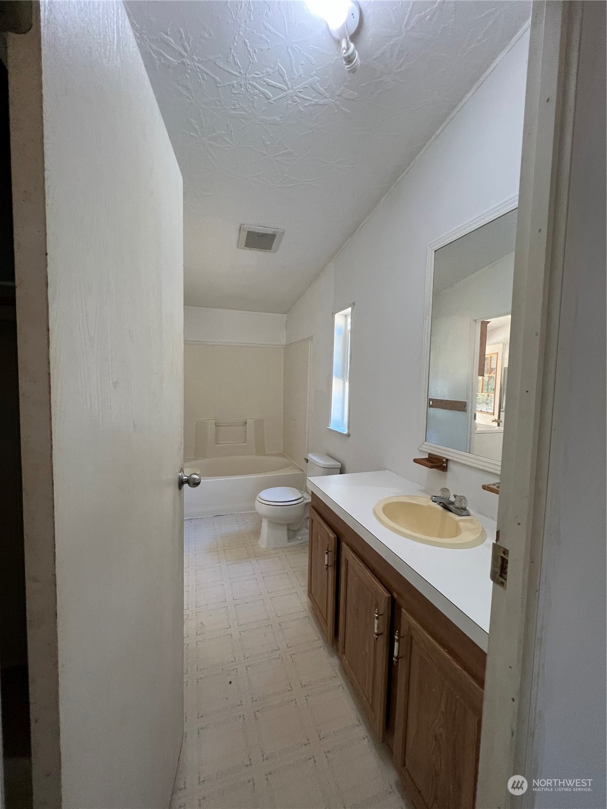 226 Limmer Road Winlock, WA 98596 - Photo 19 of 32 a spacious bathroom with a granite countertop sink a toilet and a mirror