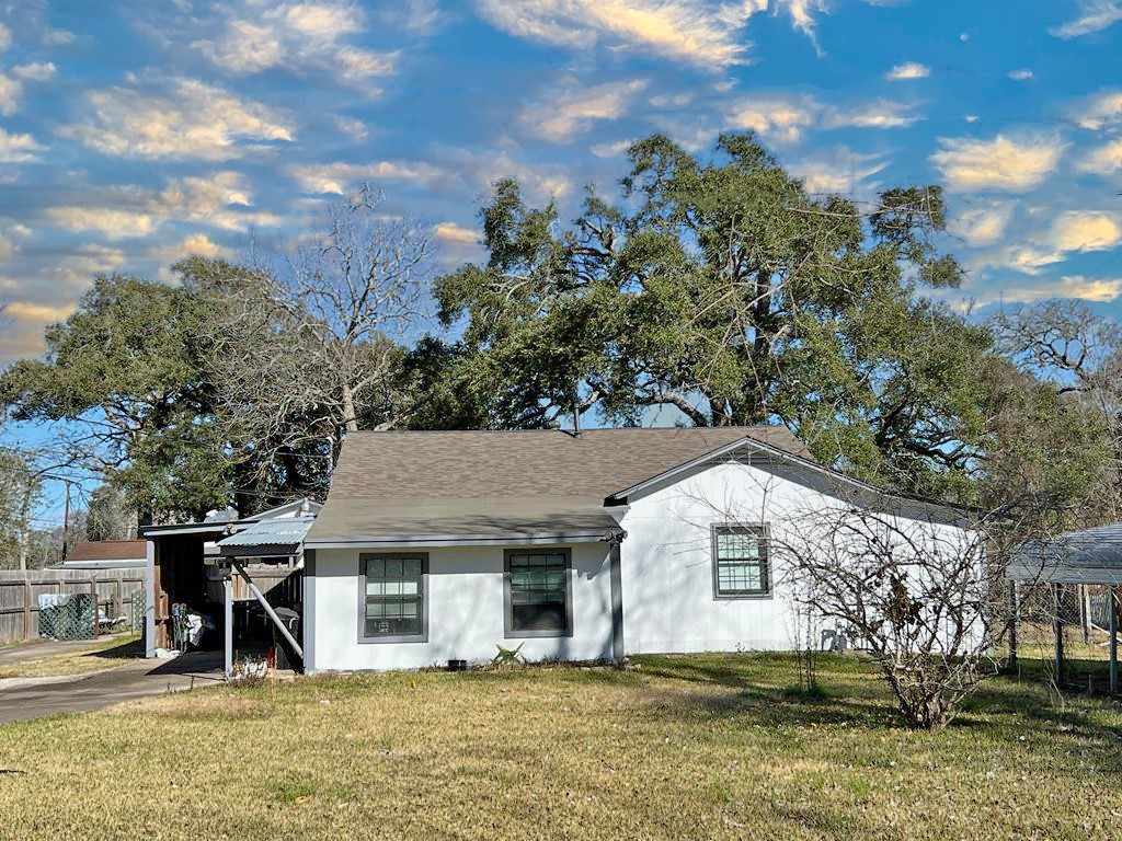 1272 Pecan Street Clute, TX 77531 - Photo 1 of 7 a front view of a house with a yard