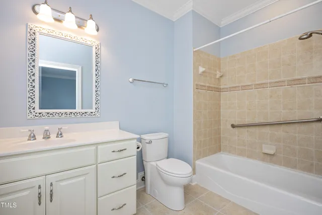 a bathroom with a toilet a sink a mirror and bathtub