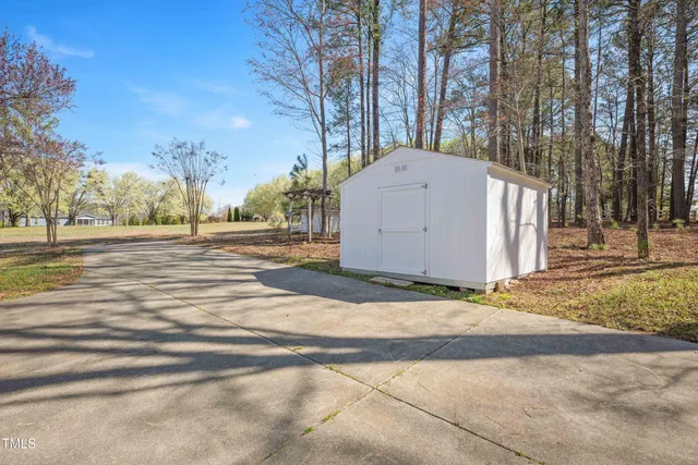 a view of a barn house in the middle of a yard