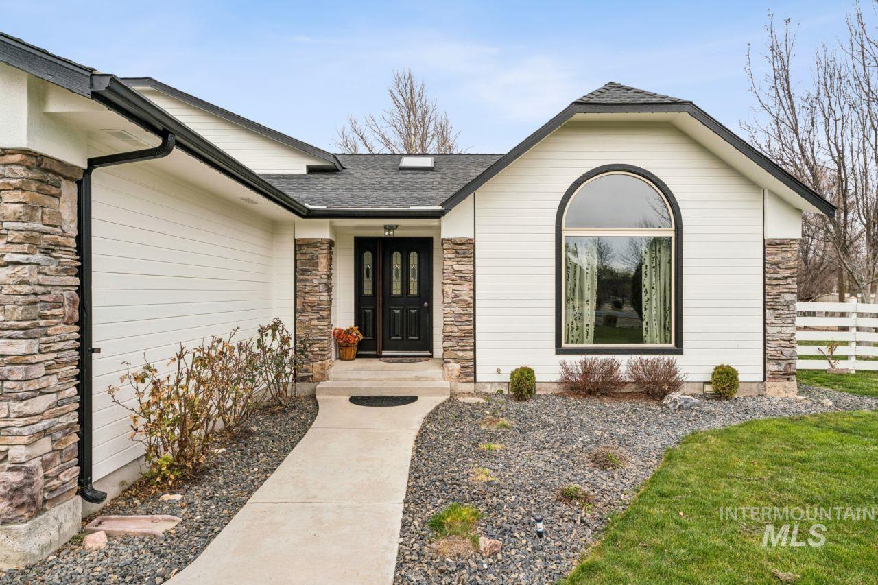 710 Keogh Lane Caldwell, ID 83607 - Photo 12 of 50 Entrance to property featuring stone siding and a shingled roof