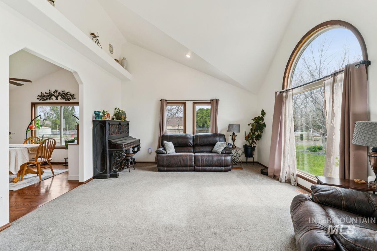 710 Keogh Lane Caldwell, ID 83607 - Photo 14 of 50 Carpeted living room with vaulted ceiling, recessed lighting, arched walkways, and ceiling fan