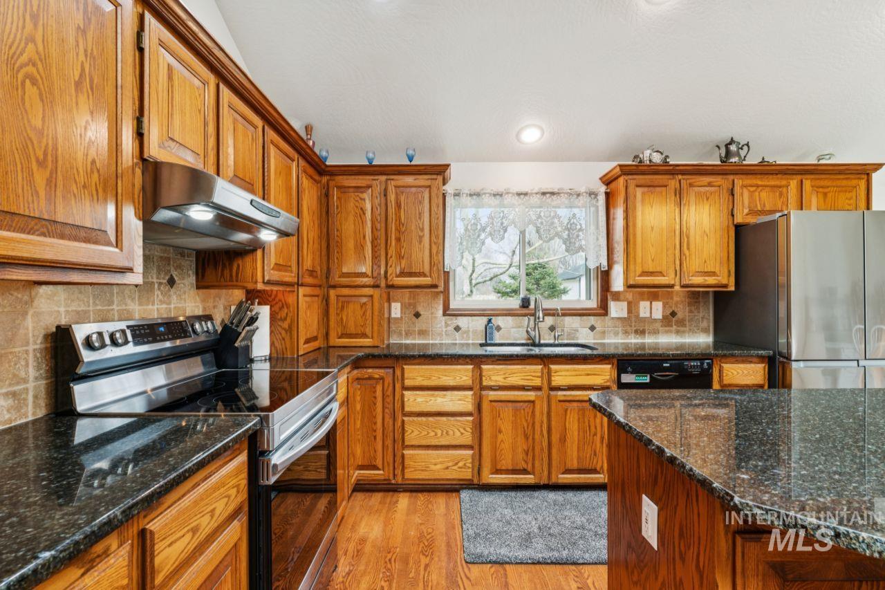 710 Keogh Lane Caldwell, ID 83607 - Photo 17 of 50 Kitchen featuring stainless steel appliances, wood finish cabinets, and light wood-type flooring