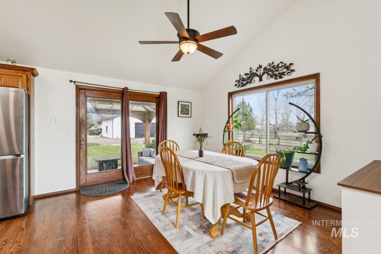 710 Keogh Lane Caldwell, ID 83607 - Photo 20 of 50 Dining space featuring dark wood-type flooring, vaulted ceiling, and a ceiling fan