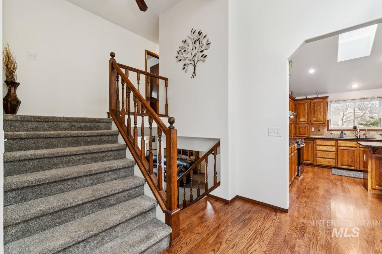710 Keogh Lane Caldwell, ID 83607 - Photo 22 of 50 Staircase featuring a skylight, wood finished floors, recessed lighting, and ceiling fan