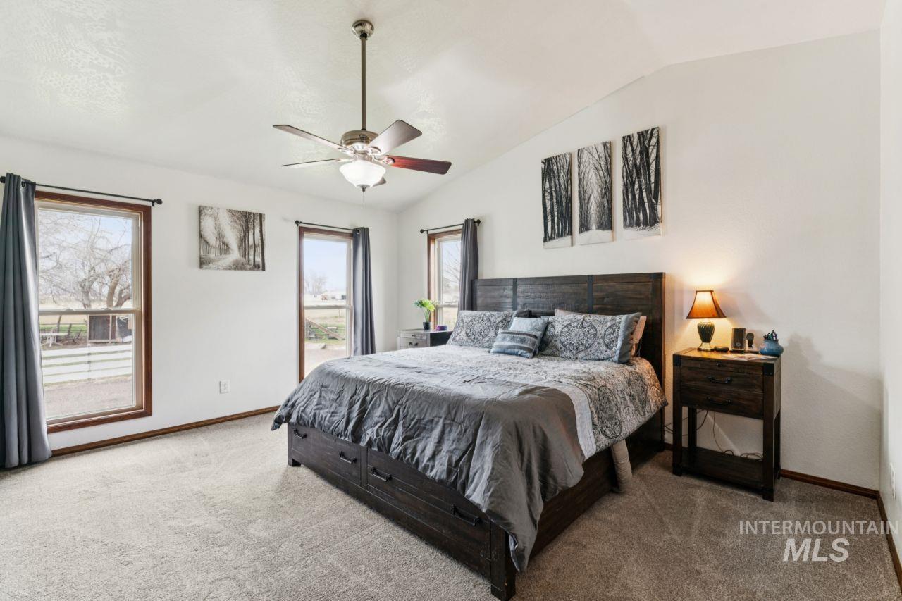 710 Keogh Lane Caldwell, ID 83607 - Photo 23 of 50 Bedroom featuring vaulted ceiling, carpet floors, and a ceiling fan