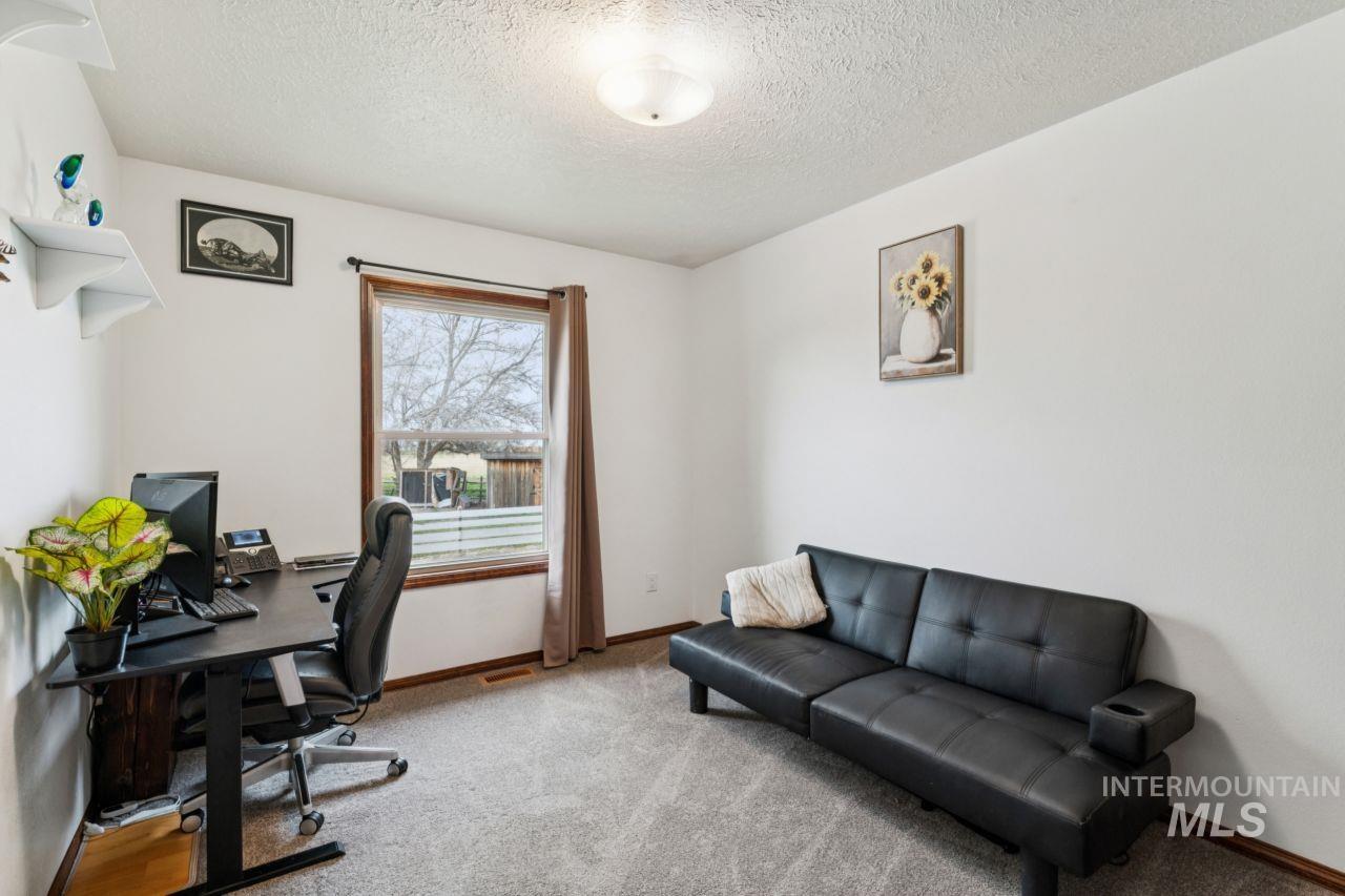 710 Keogh Lane Caldwell, ID 83607 - Photo 27 of 50 Office area with carpet floors and a textured ceiling