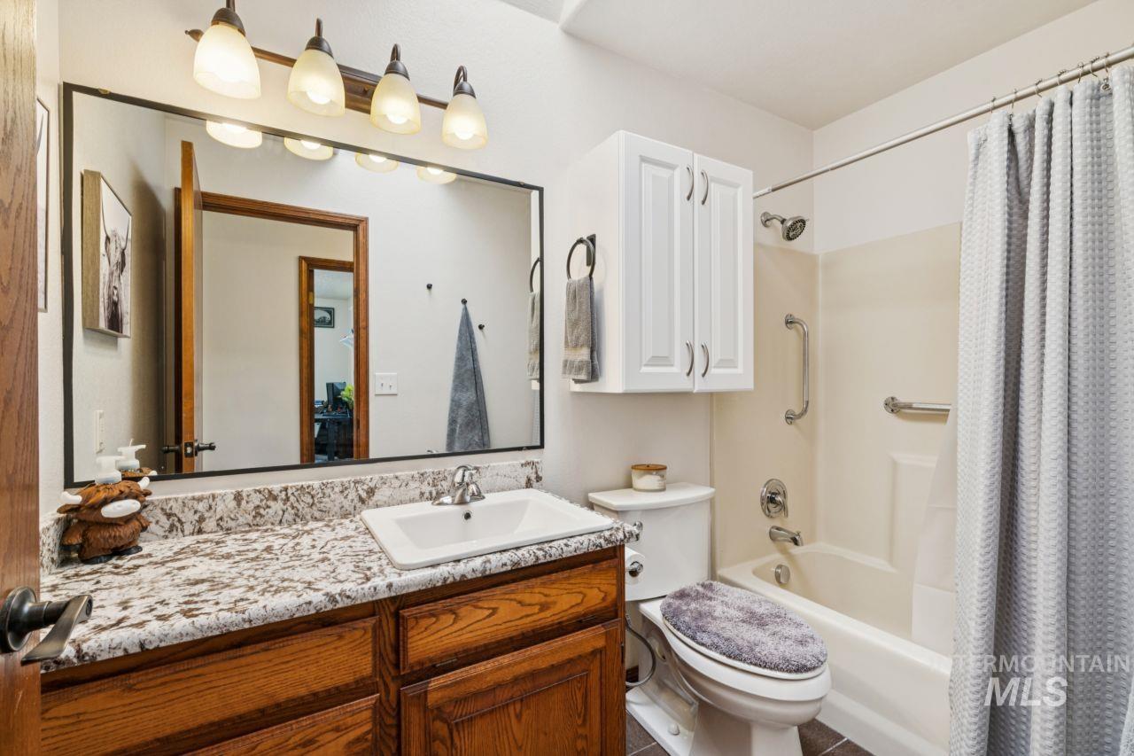 710 Keogh Lane Caldwell, ID 83607 - Photo 29 of 50 Full bathroom featuring vanity and shower / bath combination with curtain