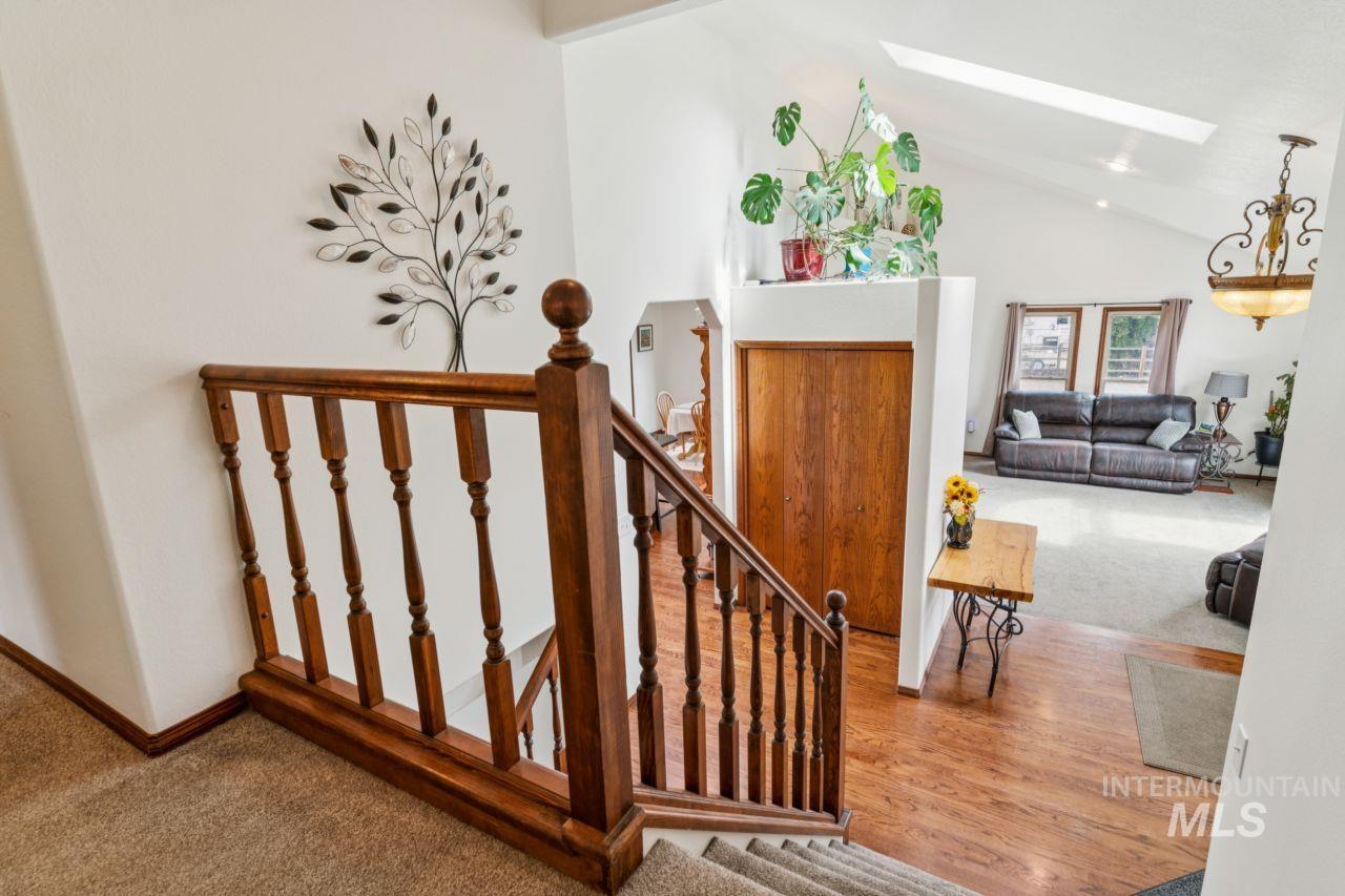 710 Keogh Lane Caldwell, ID 83607 - Photo 31 of 50 Staircase with a skylight, carpet floors, and a high ceiling