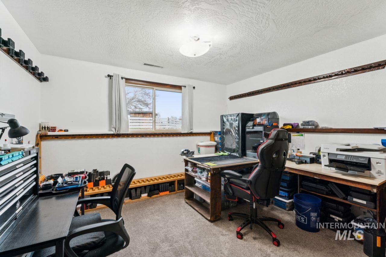 710 Keogh Lane Caldwell, ID 83607 - Photo 34 of 50 Home office featuring light carpet and a textured ceiling