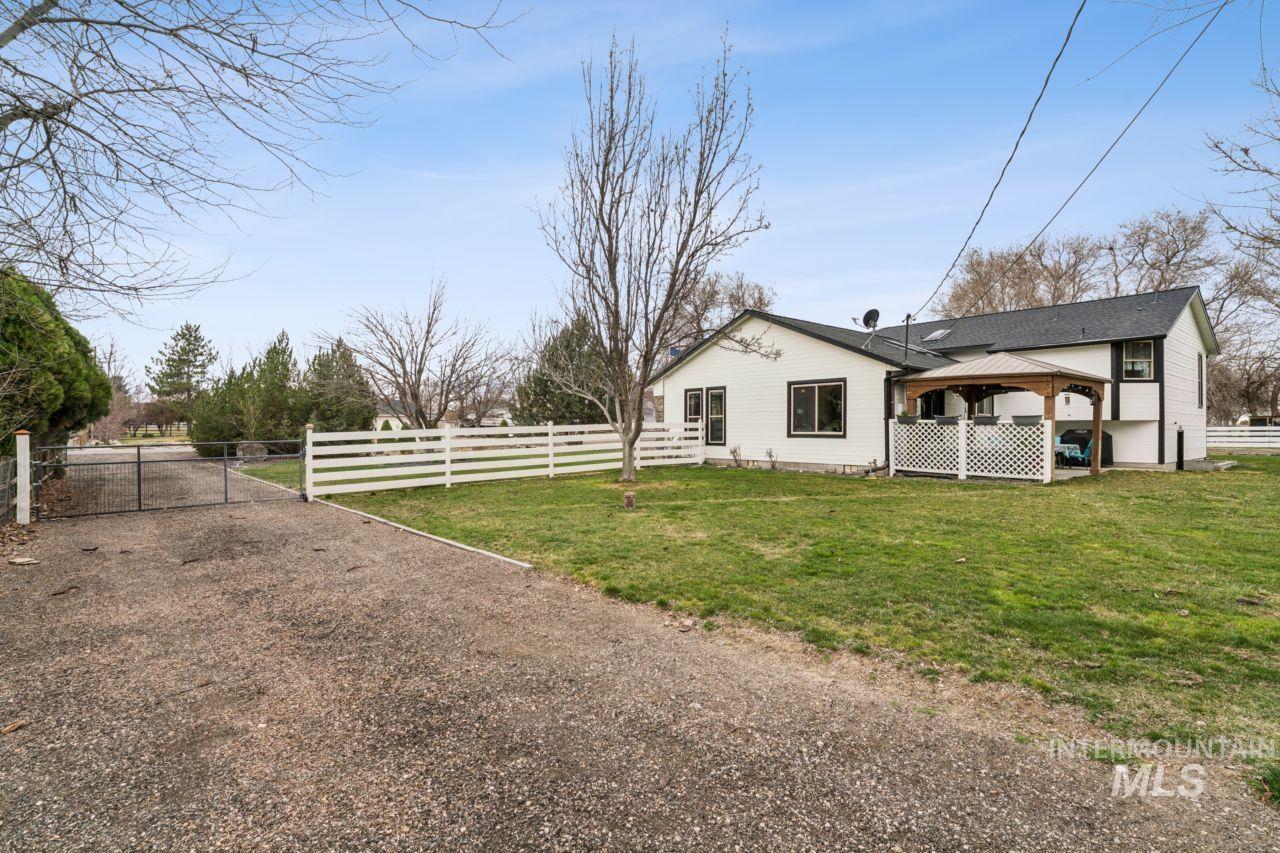 710 Keogh Lane Caldwell, ID 83607 - Photo 40 of 50 View of side of property with a gate and a gazebo