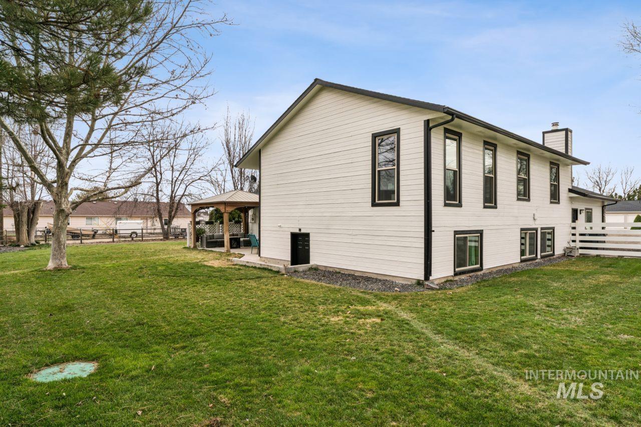 710 Keogh Lane Caldwell, ID 83607 - Photo 42 of 50 View of home's exterior with a gazebo, a chimney, and a patio