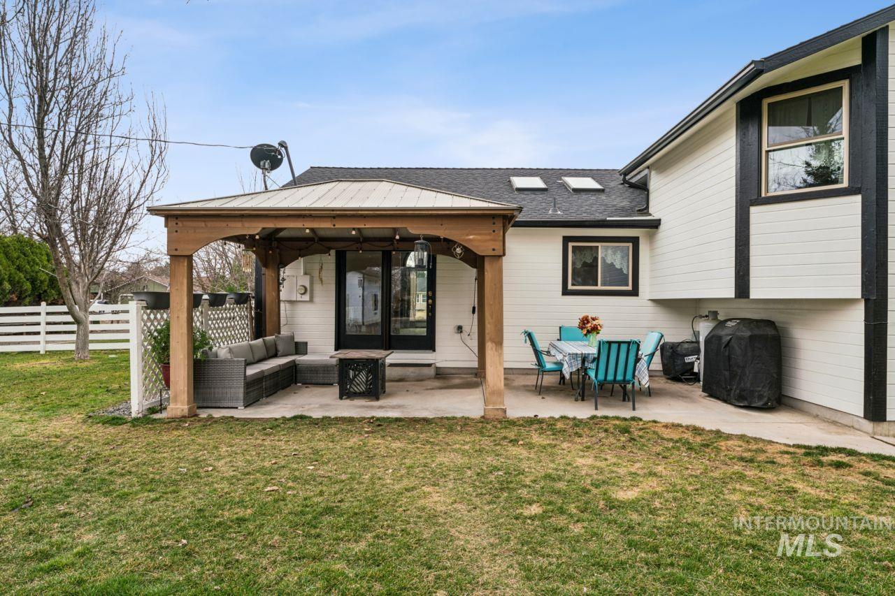 710 Keogh Lane Caldwell, ID 83607 - Photo 45 of 50 Rear view of house featuring a patio area and an outdoor hangout area