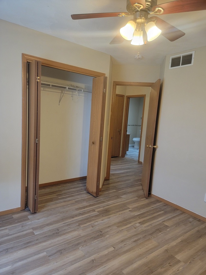 614 Bayfield Road Rockton, IL 61072 - Photo 12 of 42 a view of a room with wooden floor and a ceiling fan