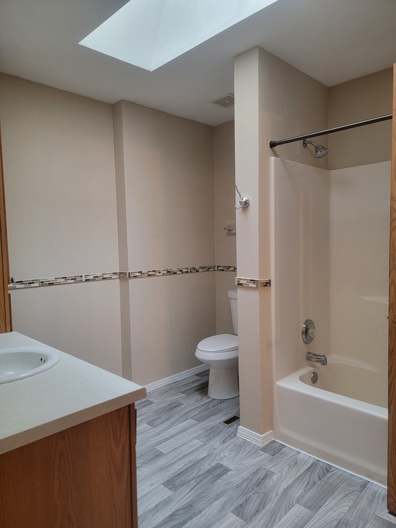 614 Bayfield Road Rockton, IL 61072 - Photo 16 of 42 a bathroom with a sink a toilet and shower