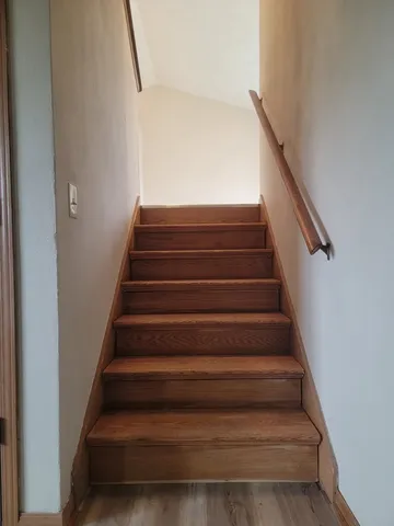 a view of empty room with wooden floor and fireplace