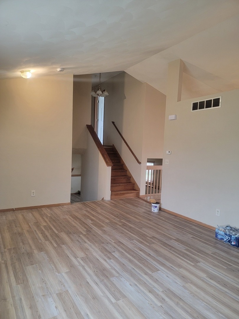 614 Bayfield Road Rockton, IL 61072 - Photo 6 of 42 a view of an empty room with wooden floor and stairs