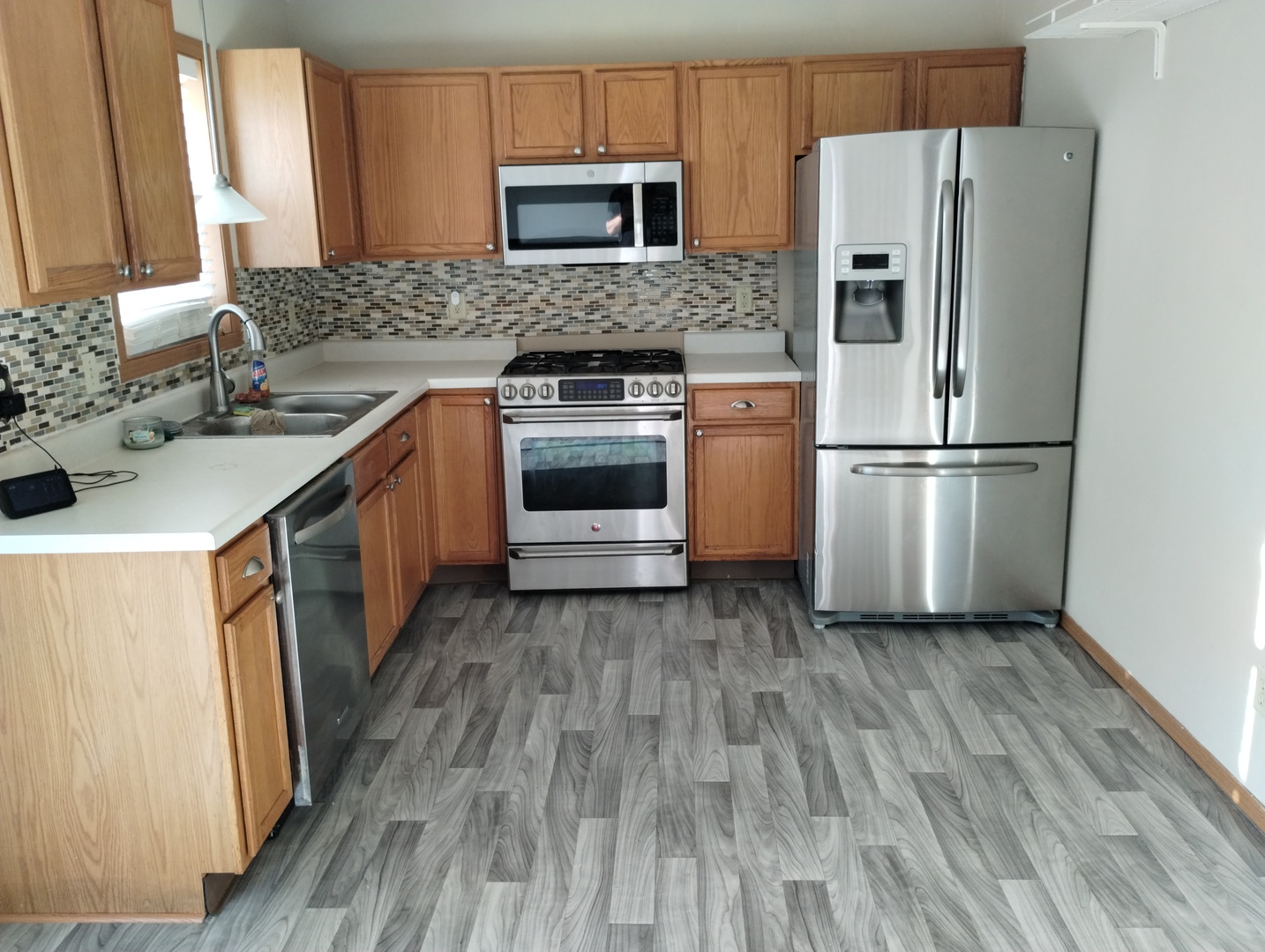614 Bayfield Road Rockton, IL 61072 - Photo 8 of 42 a kitchen with a sink a refrigerator and a stove top oven