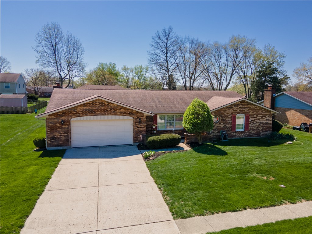 4210 Pleasanton Road Englewood, OH 45322 - Photo 2 of 34 This charming residence features a classic brick exterior and an inviting concrete driveway.