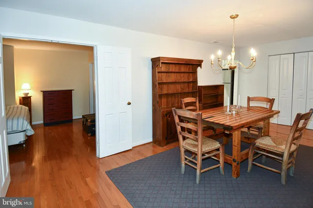 a dining room with furniture and wooden floor