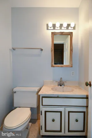a bathroom with a sink toilet and mirror